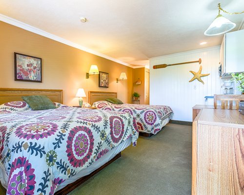 A well furnished bedroom with two queen beds.
