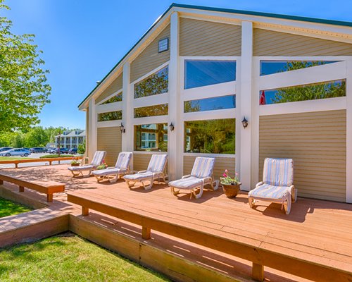 An outdoor patio with chaise lounge chairs.