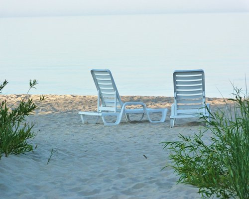 A view of chaise lounge chairs facing the beach.