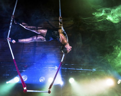 A woman performing gymnastics in the night.