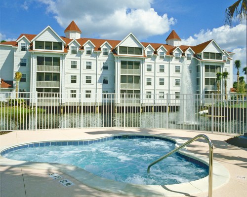An outdoor hot tub alongside multi story condos.