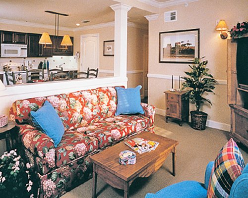 A well furnished living room with open plan kitchen and dining area.