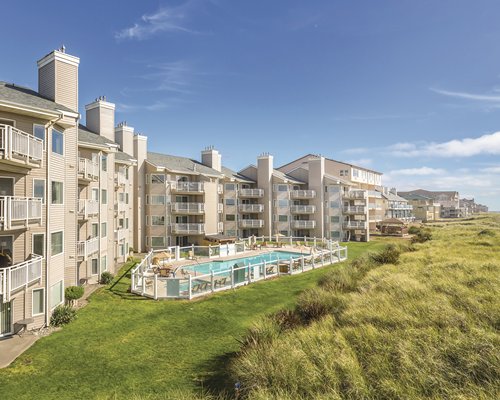 Exterior view of multiple unit balconies at WorldMark Ocean Shores with outdoor swimming pool.