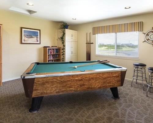 An indoor recreational room with a pool table.