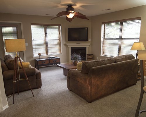 A well furnished living room with a television and fireplace.