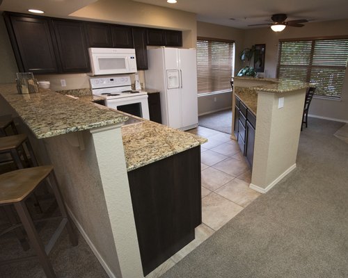 A well equipped kitchen and breakfast bar.