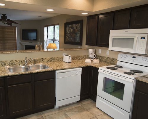 A well equipped kitchen with a microwave oven.