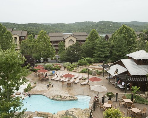 Aerial view of an outdoor swimming pool alongside the resort.