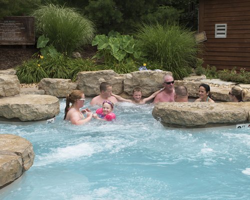 View of people at an outdoor swimming pool.