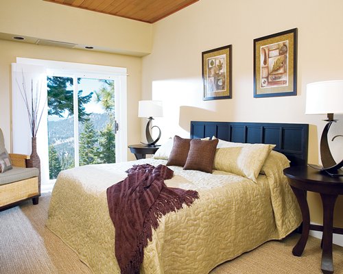A well furnished bedroom with an outdoor view.