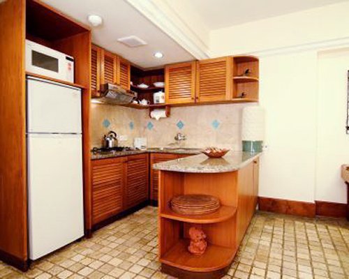 A well equipped kitchen with a microwave and refrigerator.