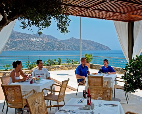 An outdoor restaurant with a beach view.