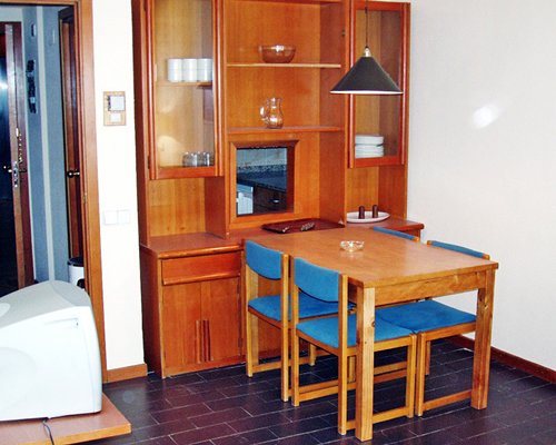 A well furnished dining room with a television.