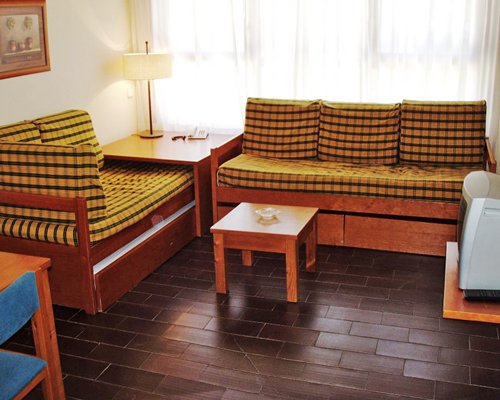 A well furnished living room with a television and outside view.