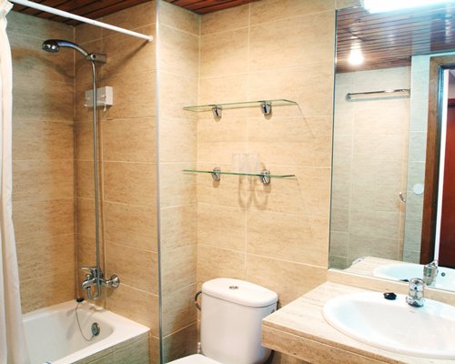 A bathroom with a bath tub and shower stall.