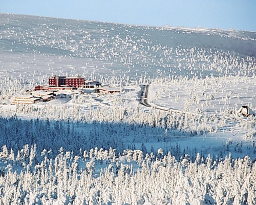 An exterior view of Hogfjallet resort covered in snow.