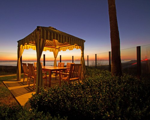 Scenic exterior view of multiple unit balconies at Carlsbad Seapointe Resort with a fountain.