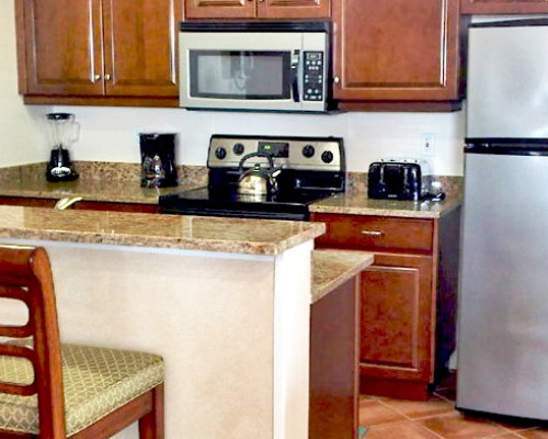 An open plan kitchen with breakfast bar.