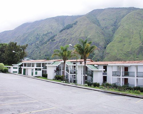 Exterior view of Guadalupe Resort with a pathway alongside mountains.