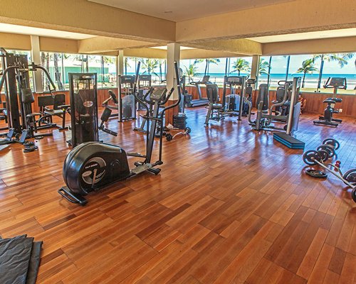 An indoor fitness center with an outside view.