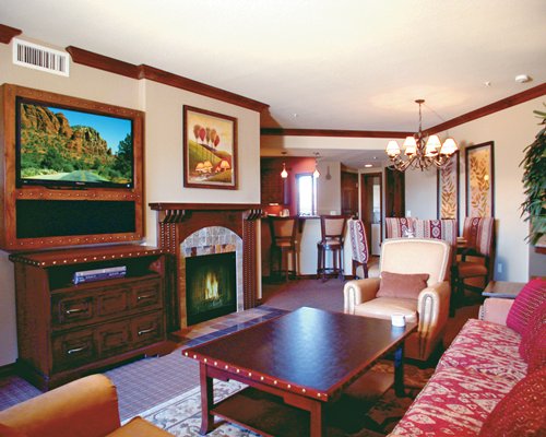 An open plan living room and dining area with a television and fireplace.