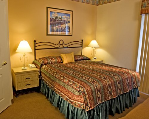 A well furnished bedroom with queen bed.