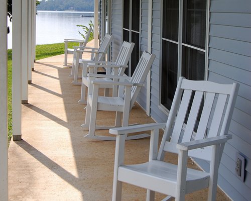 A view of patio furniture alongside the waterfront.