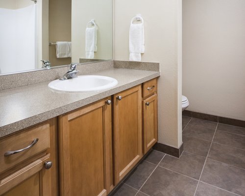 A bathroom with single sink vanity.