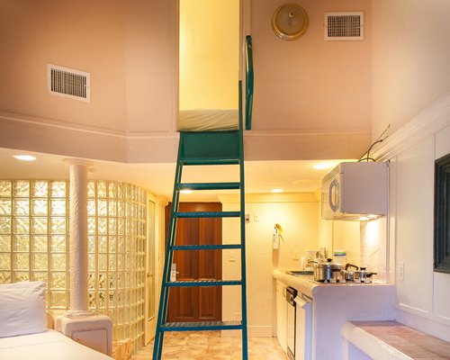 A view of an indoor ladder alongside a kitchen.