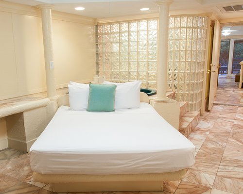A well furnished bedroom with a hot tub.