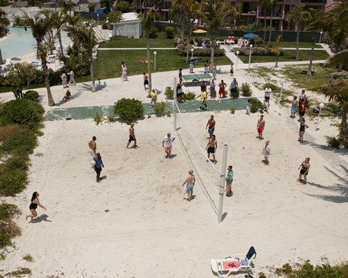 Group of people playing beach volleyball.