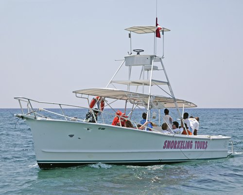 A view of people sailing on a medium sized boat.