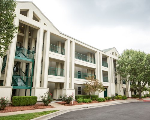 An exterior view of a resort unit alongside trees.