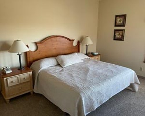 A well furnished bedroom with a king bed and an outside view.