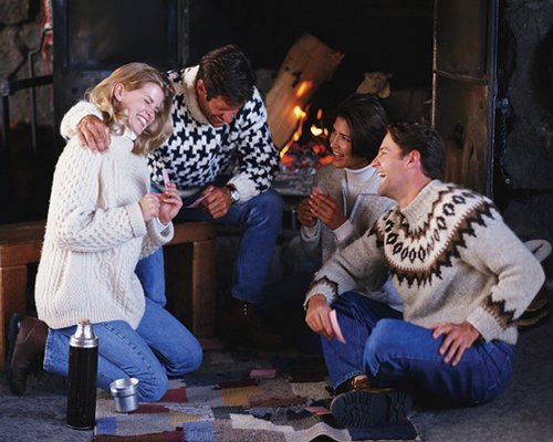 Couples inside a room with fireplace.
