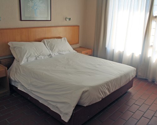 A well furnished bedroom with an outside view.