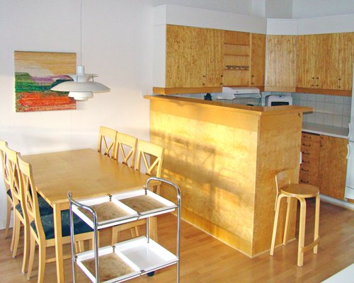 A well furnished dining area alongside a kitchen.