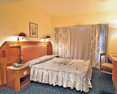 A well furnished bedroom with a double bed.