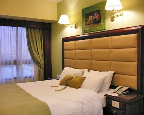 A well furnished bedroom with an outside view.