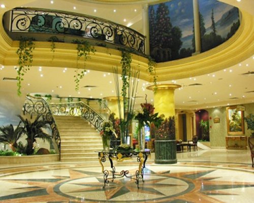 Lounge area at Pyramisa Cairo with a stairway and indoor balcony.