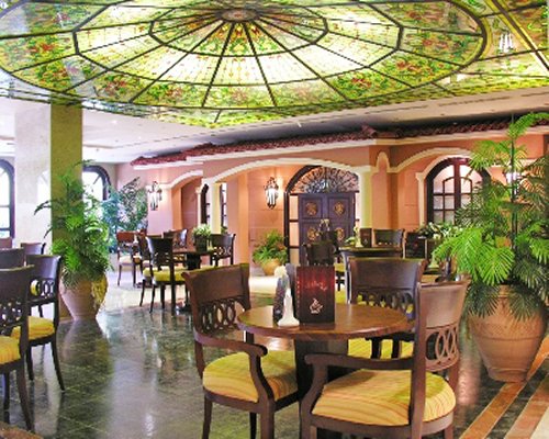 An indoor restaurant with potted plants.