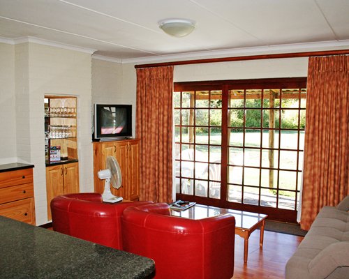 A well furnished living room with a television and outside view.
