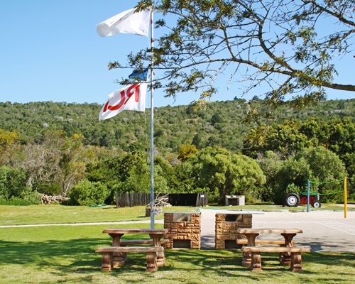 Picnic area with volleyball court surround by landscaping.