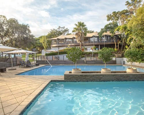 An outdoor swimming pool alongside multiple resort units.