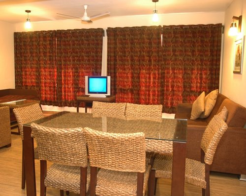 An open plan living and dining area with a television.