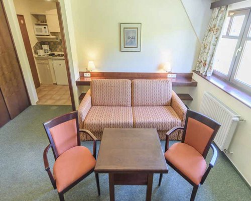 A well furnished living area alongside kitchen.