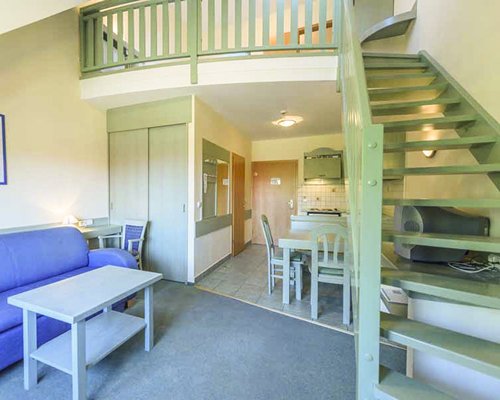 An open plan living and dining area alongside the stairway.