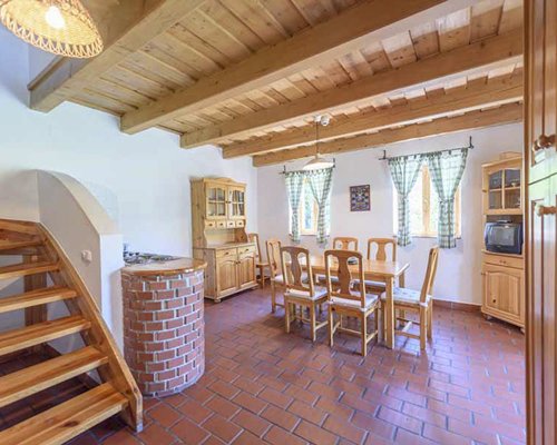 A well furnished dining area with a television.