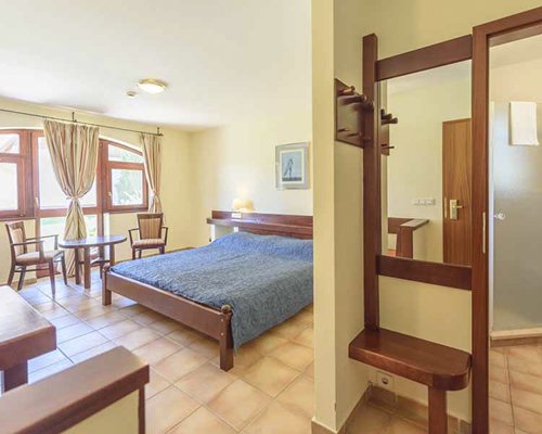 A well furnished bedroom with patio furniture.