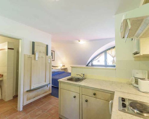 An open plan kitchen with bedroom.